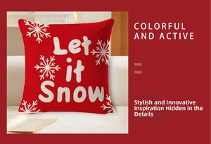 Detail of red linen Christmas pillow cover featuring white snowflakes and Let it Snow text