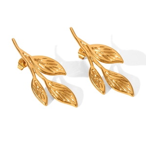 Detailed view of gold leaf and branch stud earrings with a polished metallic finish