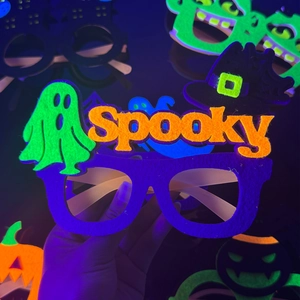 Neon Halloween glasses with purple felt frame and glowing green ghost for party fun