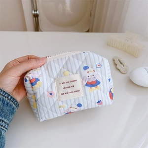 Détail de la trousse de maquillage matelassée à rayures bleues avec lapins mignons