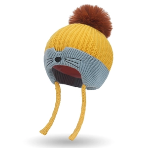 Winter knit baby hat with ear flaps, pom-pom, and cute animal face in yellow and blue