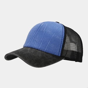 Detail of vintage washed trucker hat with breathable black mesh and blue textured fabric