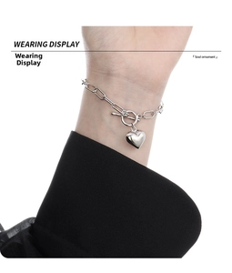 On-wrist display of heart pendant chain bracelet with OT toggle clasp in silver finish