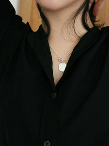 Elegant 925 sterling silver necklace with irregular coin pendant and OT clasp on model