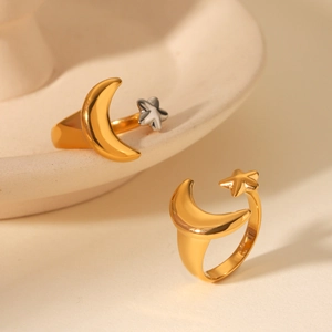 Close-up of gold and silver two-tone stainless steel ring with star and moon design
