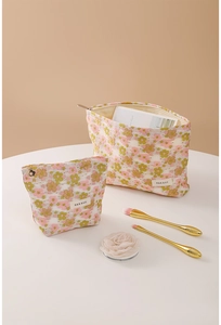 Detail of floral makeup bag set with H&R BAG label and metal zipper closure