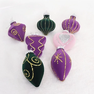 Detailed view of flocked purple green and pink Christmas ornaments with gold patterns