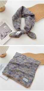 Detail of gray floral cotton linen scarf with yellow lace trim and floral pattern