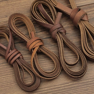 DIY brown leather cords for jewelry making displayed on a vintage wood background