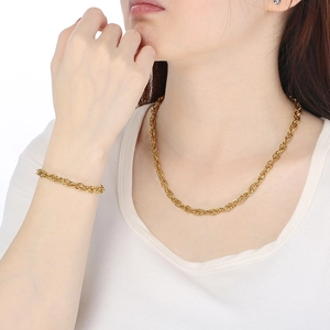 Handmade gold twisted rope chain necklace and bracelet set worn by a fashion model