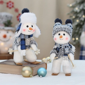 Christmas snowman dolls with blue plaid hats and wooden skis for holiday table decoration