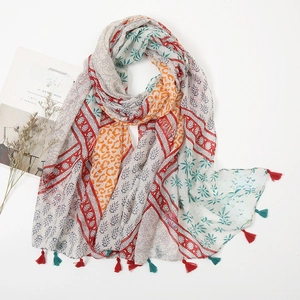 Detail of floral and leopard print cotton linen scarf with colorful tassel fringes