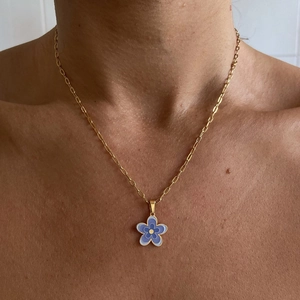 Layered 18k gold plated titanium steel necklace with purple floral pendant on a model