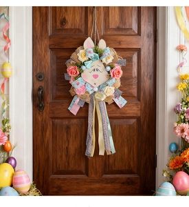 Detailed view of an Easter door wreath with rabbit face, colorful eggs and ribbons