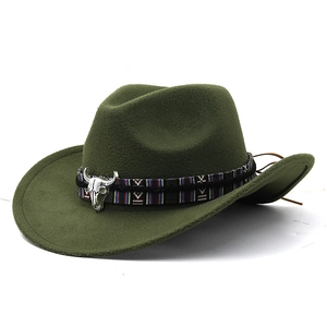 Close-up of olive green western felt hat featuring a silver bull head metal emblem and ethnic band