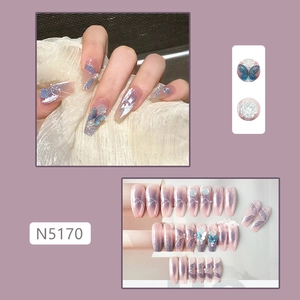 Macro detail of coffin press-on nails with purple gradient, 3D butterflies and white flowers