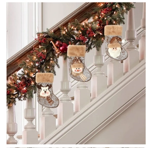 Three rustic Christmas stockings with reindeer snowman and Santa on staircase