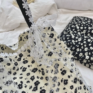 Close-up of floral canvas bag with white lace embroidery and large ribbon bow detail