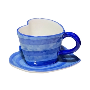 Blue and white striped heart-shaped ceramic coffee cup and saucer set on white background