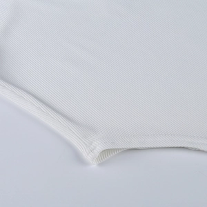 Close-up of white ribbed knit fabric texture and high-quality stitching on sportswear
