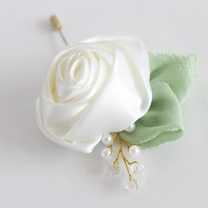 Elegant white satin rose boutonniere with green leaf and pearls for wedding suits
