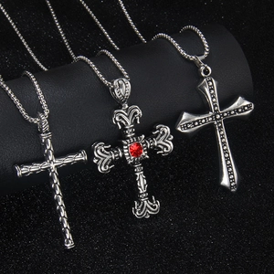Three vintage stainless steel cross necklaces with diamond accents and red gemstone pendant