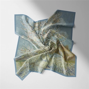 Detail of artistic Van Gogh almond blossom silk scarf with elegant blue border and fold texture