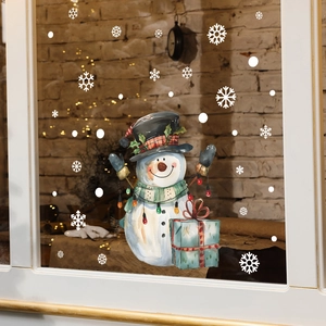 Christmas snowman wall sticker with gift box and white snowflakes on a cozy window