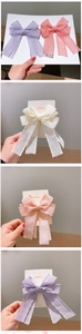 Detail of handmade macaron organza ribbon bow hair clips with wavy edges for girls