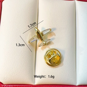 Macro detail of a gold airplane brooch with crystals and precise size measurements