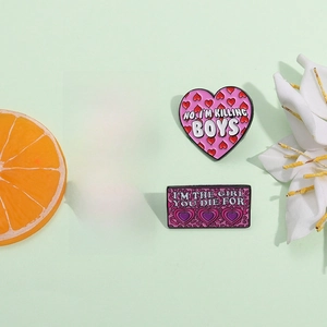 Pink heart and rectangular enamel Mood Reader pin badges with personalized typography phrases