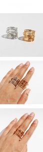 Detail of wide multi-layer spiral ring in gold and silver finishes on a model