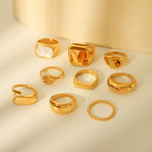 Set of 9 gold-plated stainless steel rings with geometric designs and shell inlays