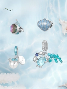 Macro shot of S925 sterling silver ocean charms with blue enamel shells and sea turtles