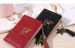 Close-up of short bifold wallets with tassel and heart pendant in red and black colors