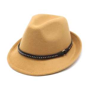 Detail of camel wool fedora hat featuring black rivet band and golden metal buckle clasp