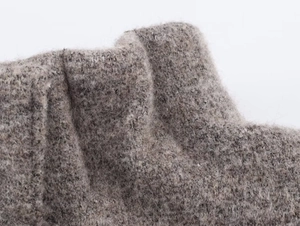 Close-up of premium grey wool-like knitted fabric texture on bomber jacket set