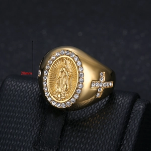 Macro view of gold plated Virgin Mary ring with inlaid rhinestones and cross details