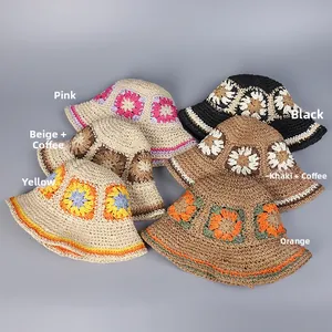 Macro detail of handmade crochet sun hats showing colorful granny square flower patterns