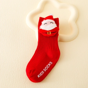 Detail of red Christmas kids socks featuring a Santa doll and vertical knit stripes