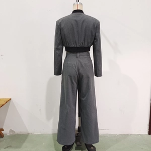 Back view of gray pinstripe cropped blazer and high-waisted wide-leg suit trousers