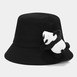 Detail of cute plush panda ornament on a black cotton bucket hat for children