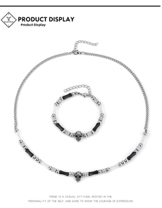 Close-up detail of vintage punk skull necklace and bracelet set with silver chain and stones