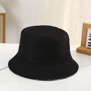 Close-up of black bucket hat showing high-quality twill fabric texture and flat top design