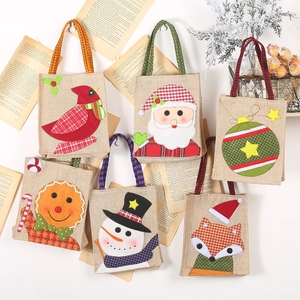 Christmas burlap gift bags with embroidered festive patterns of Santa and snowman