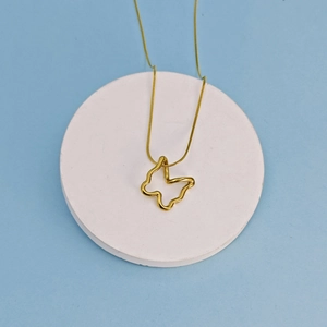Classic golden hollow butterfly pendant necklace on a blue background with snake chain