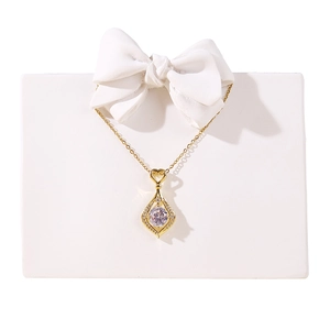 Creative resin necklace stand with gold heart and drop-shaped pendant on white bow sculpture