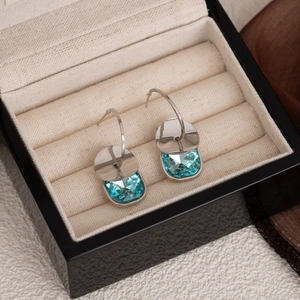 Elegant blue crystal bubble earrings in silver setting, displayed in a black jewelry box