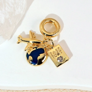 Gold travel pendant set featuring airplane, blue globe, and heart passport charms