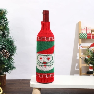 Detail of knitted Christmas wine bottle cover featuring festive Santa Claus pattern